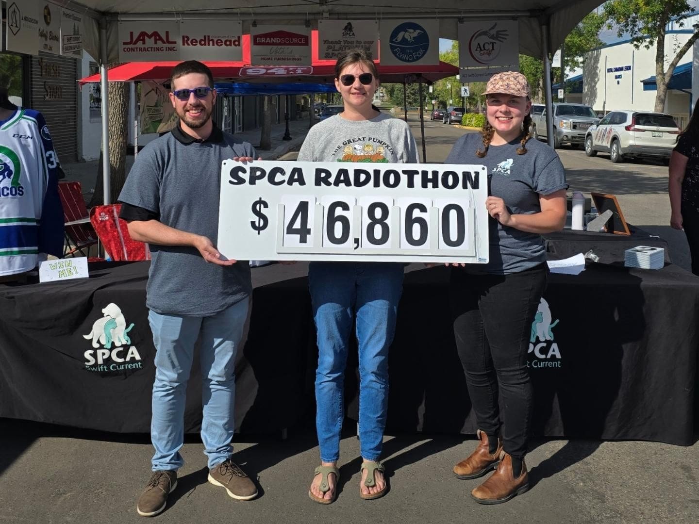 total David Zammit, Marissa Wolfe, and Kate Andriushyn pose with the grand total for the 2024 Radiothon, $46,860.
