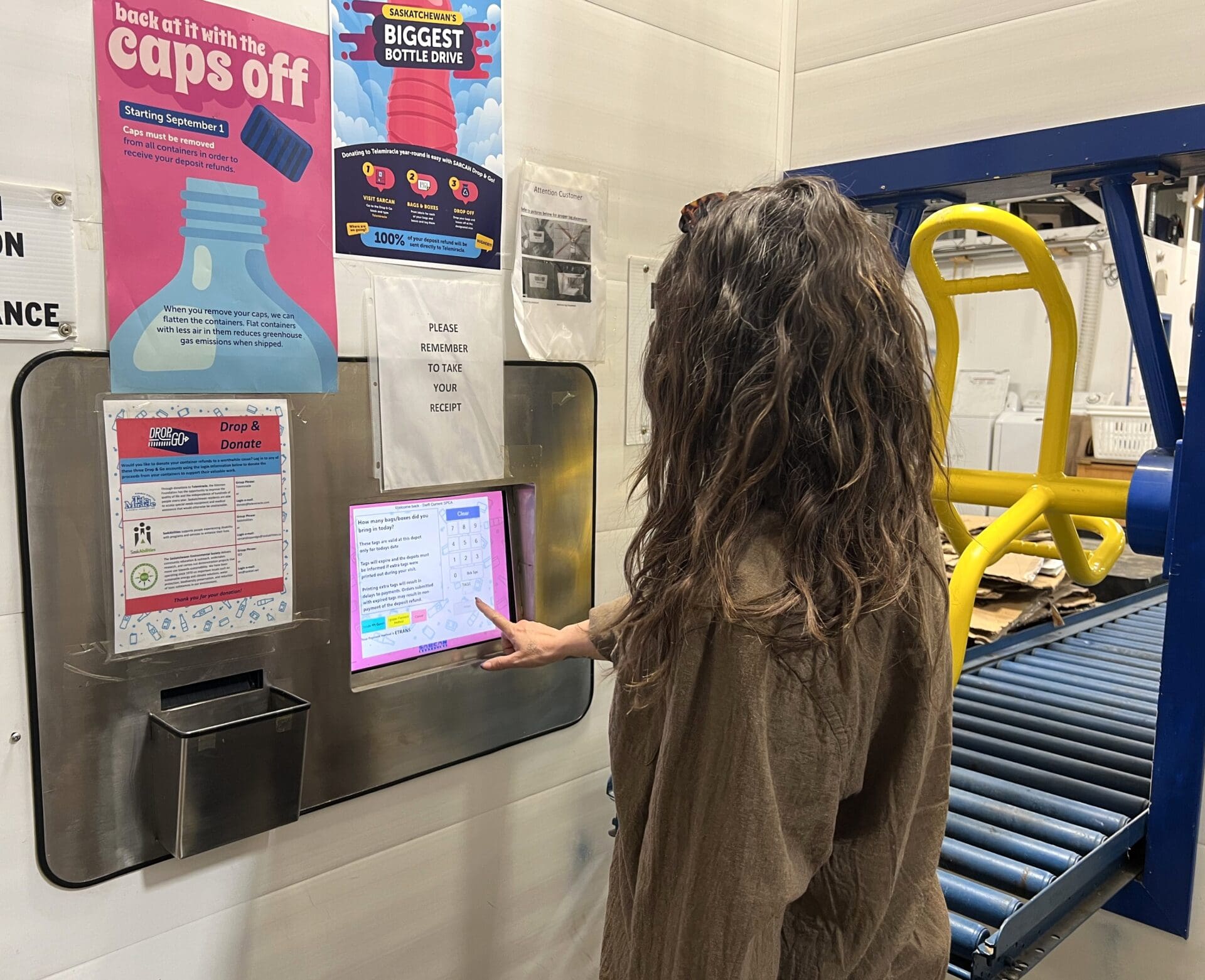 recycle_sarcan Woman uses the drop and go system at SARCAN to donate to SPCA.